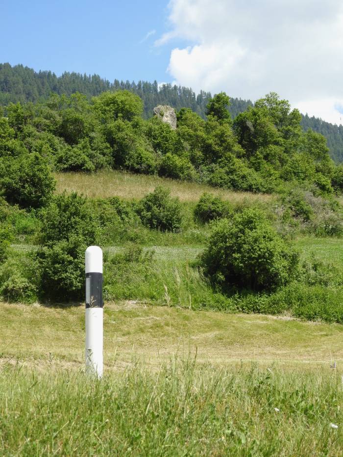 Oben im Gebüsch gut zu erkennen: Die «pedra fitta», der schmückende Stein des einstigen Talweges, gerade unterhalb von Sent, kurz vor Crusch gelegen.